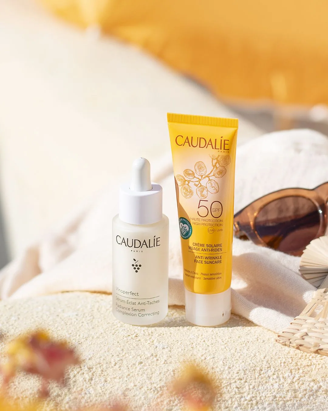 Caudalie skincare products on the beach